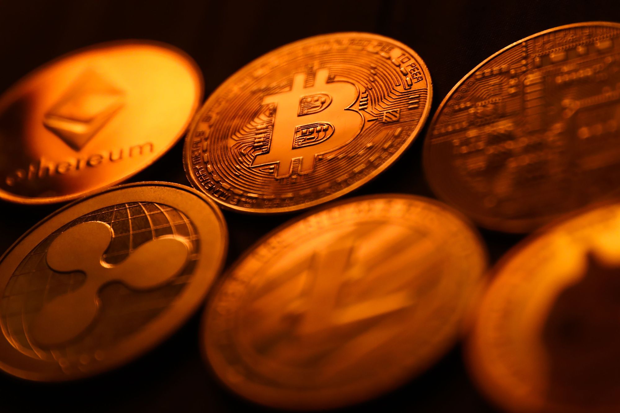 Close-up of IRS tax forms with golden Bitcoin and Ethereum coins symbolizing new 2025 crypto tax reporting rules
